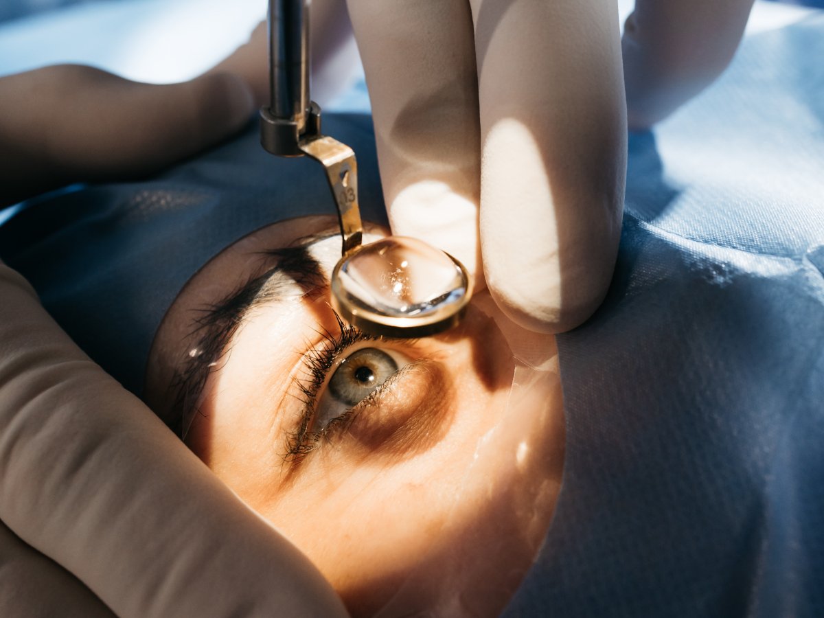 A surgery scene with hand in lab gloves and close up of eye.