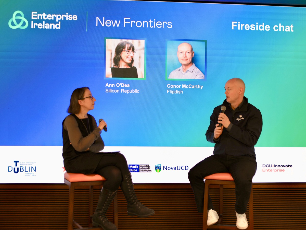 One woman and one man in front of blue screen with microphones
